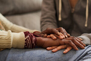 daughter holding mother hands and comforting her daughter holding mother hands and comforting her